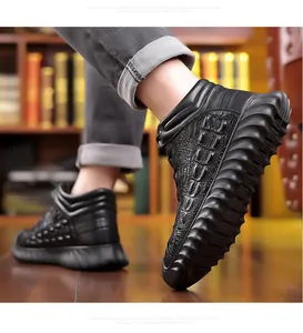 Close-up of black high-top leather boots with crocodile texture and thick sole