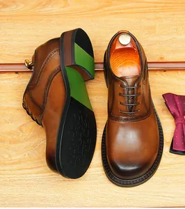 Detailed top view of premium brown burnished leather Oxford shoes with brogue details