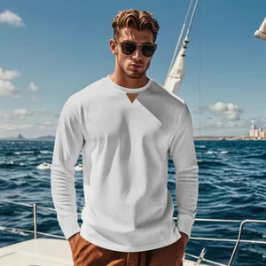 Close-up detail of a white corduroy long sleeve top with crew neck and triangle patch