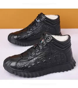 Detail view of black cowhide leather winter boots with warm wool lining and crocodile pattern
