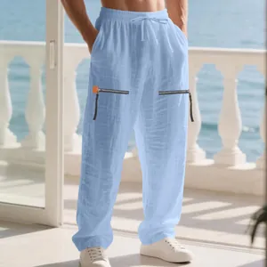 Detailed view of men's loose linen beach pants with stylish zipper design in blue.