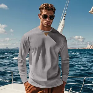 Men's grey ribbed corduroy long-sleeve top with decorative collar patch on boat