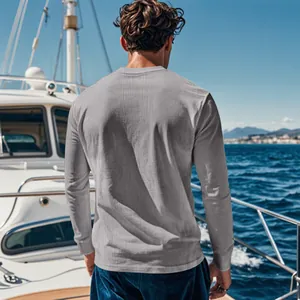Back view of a men's grey ribbed corduroy long-sleeve top on a luxury yacht.