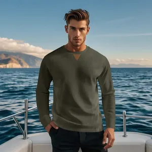 Detailed view of men's olive green ribbed corduroy crewneck long sleeve shirt on a yacht