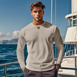 Detail view of men's ribbed corduroy crew neck long sleeve shirt in a nautical outdoor setting.