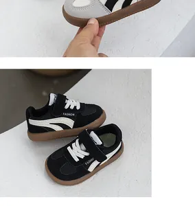 Detail view of stylish children's non-slip sneakers in black and white with retro gum soles