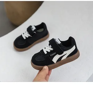 Close-up detail of black and white children's German trainer sports sneakers for kids.