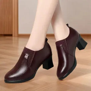 Detail of women's burgundy block heel loafers with textured leather and B logo