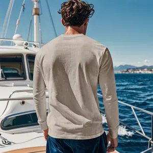 Back view of men's sand-colored ribbed long-sleeve shirt on a luxury yacht deck