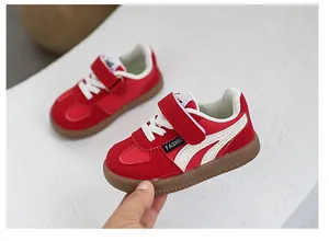Close-up of red and white toddler athletic sneakers with Velcro straps
