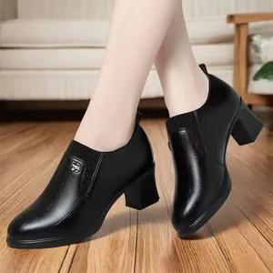 Elegant black textured leather pumps with chunky heels and a pointed toe design