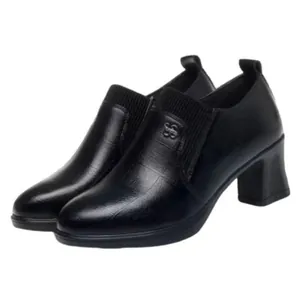 Detail showing the knitted collar and textured leather of these elegant black loafers.