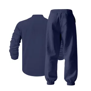 Back view detail of a navy blue loose linen long-sleeve Henley shirt and pant set.