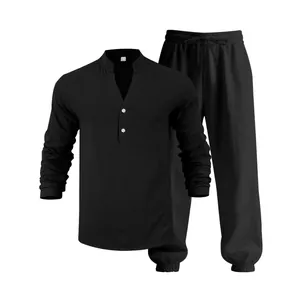 Detailed view of black men's linen long sleeve Henley shirt and drawstring pants set.