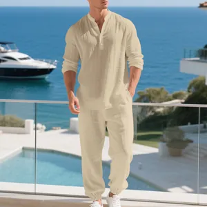 Detailed view of men's loose beige linen Henley shirt and pants set at a luxury resort