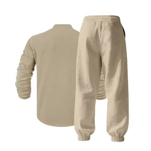 Back view of a beige men's loose linen lounge set with a long sleeve shirt and pants