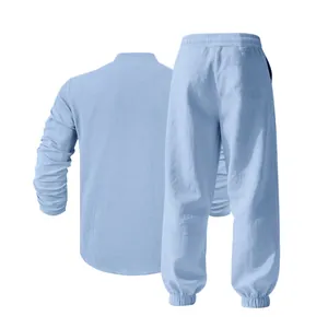 Back perspective showing texture of men's light blue linen Henry shirt and lounge pants set