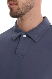 Detail of long-sleeved polo shirt with Alepeson embroidery on collar and pearl pique texture.