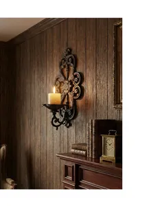 Vintage European cast iron wall-mounted candle holder in an elegant library setting