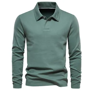 Detailed macro view of a sage green long sleeve polo shirt with embroidered collar