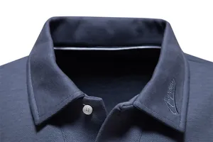 Close-up of navy blue men's polo shirt collar with embroidered logo and button