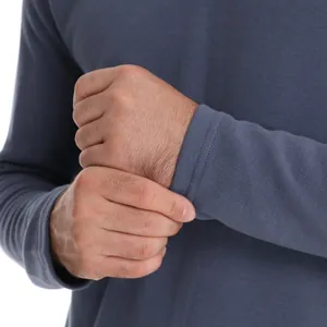 Close-up of a men's blue long sleeve pique cotton polo shirt with ribbed cuffs.