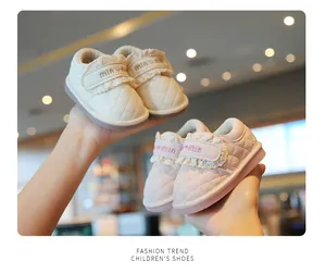 Detail view of quilted leather toddler shoes with lace trim and Velcro strap