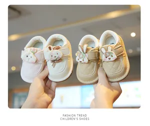 Detail view of cute cartoon bunny baby walking shoes in soft pastel colors