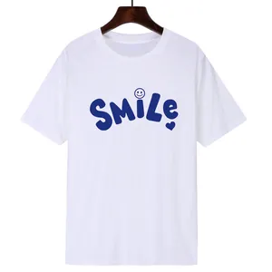 Classic white round neck cotton T-shirt featuring blue SMILE graphic print and heart