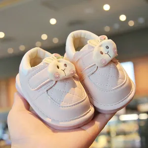Adorable pink infant walking shoes featuring a cartoon rabbit and soft non-slip soles