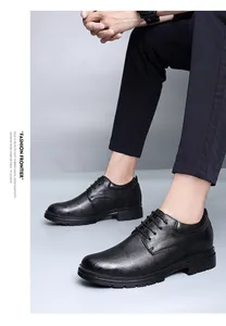 Detail view of black leather height increasing dress shoes with crocodile texture