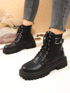 Detailed view of stylish black platform combat boots with buckle and lace-up details
