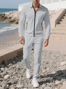 Full view of men's grey textured tracksuit set in an outdoor beach setting