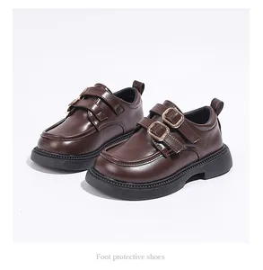 Detailed view of classic brown girls' Mary Jane loafers with double gold buckles and thick soles