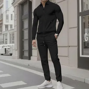Full view of men's black waffle texture casual two-piece suit with zip jacket and pants.