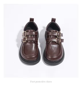 Top view of brown children's dress shoes with double buckles and rubber soles