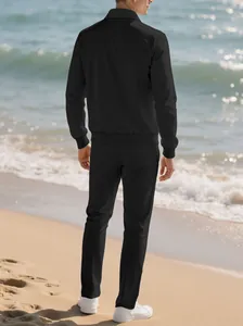 Back view of men's black textured long-sleeved casual tracksuit set at the beach