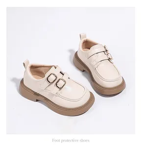 Detail view of elegant cream-colored girls' double buckle loafers for spring wear