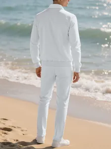 Back view of men's white textured leisure two-piece set on a sunny beach background.