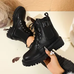 Classic British style black platform combat boots with lace-up and buckle detail for women