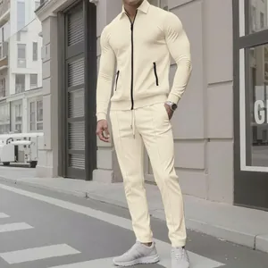 Full-body detail showing men's beige textured two-piece casual set in urban street.