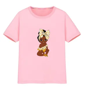 Close-up detail of African American baby girl iron-on heat transfer patch on a pink kids tee