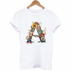 Close-up view of a decorative floral letter A heat transfer print on a white T-shirt.