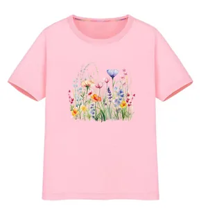 Detailed view of a vibrant wildflower watercolor print on a soft pink cotton t-shirt
