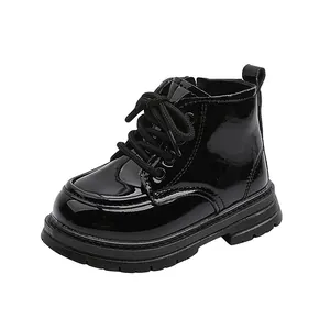 Detail of black patent leather children's boots with thick anti-slip sole