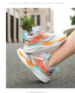 Detailed view of breathable mesh boys running shoes with orange gradient and rotary buckle