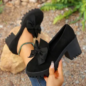 Detailed view of black chunky heel platform Mary Jane shoes with stylish bow