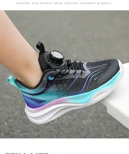 Detailed side view of stylish boy's athletic sneaker with gradient mesh and rotary dial