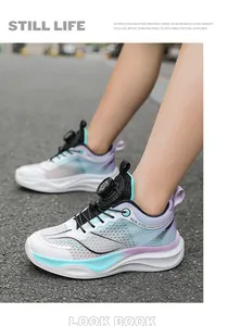 Close-up detail of breathable mesh kids' running shoes with rotary buckle in gradient blue