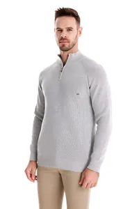 Model wearing light grey men's half-zip ribbed knit sweater against white background